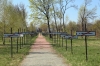 Ukraine, Chernobyl Tour with Solo East - In the middle of the Chernobyl Memorial Complex these signs represent the towns lost after the disaster, with the white signs being Ukranian towns and the black ones being Belarussian towns