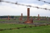 Poland, Auschwitz II - Birkenau - Remains of Section BII taken through the fence that separated Section BIIa from BIIb; most of this section was destroyed by the retreating Nazi's in an attempt to cover up their crimes