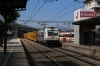 Renfe 253033 passes through El Escorial with a freight