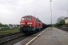 DB 217007 passes through Kaufering with a loaded ballast train having just exited the stone loading point just on the Buchloe side of the station