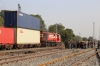 KTE WDG3A 14643 heads north from Marwar Jn with a double-stack container train, running by a crowd of people, who are gathered around the body of someone decapitated by 15013 0100 Jaisalmer - Kathgodam, when it arrived an hour earlier