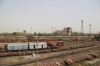 79431 1515 Ahmedabad Jn - Mahesana Jn DMU runs towards Sabarmati Jn station. SBI YDM4's 6666 & 6557 on BG flat wagons in the yard adjacent to Sabarmati Town station, having completed its journey from IZN, via a Marwar Jn stop-over