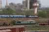 ABR WDM3A 14117 departs Sabarmati Jn with 19412 0625 Ajmer Jn - Ahmedabad Jn. Stabled in the yard adjacent to Sabarmati Town is SBI YDM4 6557 on a BG flat wagon (6666 is out of sight)