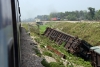 Derailed Garib Rath coaches near Gasaigaon Hat, east of NJP, WDM3D 11138 heads an eastbound freight in the background