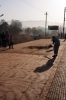 A woman attempts to clean the platform of dust, a particularly fruitless task, at Barbil Railway Station, Orissa, India