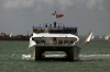 A Wightlink Catamaran arrives after finding a way through the JP Morgan round the Island boat race off the coast of Ryde as the boats near the end at Cowes