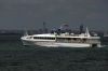 A Wightlink Catamaran plots its way through the JP Morgan round the Island boat race off the coast of Ryde as the boats near the end at Cowes