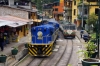 Peru Rail MLW DL535 #482 shunts an Expedition coach, from Machu Picchu, onto the rear of the local train 21 0700 Cusco San Pedro - Hidroelectrica, at Aguas Calientes; meanwhile the van is unloaded by locals at the front of the train. Non-residents can only travel with this train from Aguas Calientes to Hidroelectrica.