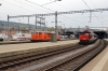 Rail Transport Service (RTS) 2143025 stands at Zurich Hbf while SBB 922003 shunts stock and an ICE set waits departure