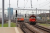 Rail Transport Service (RTS) 2143025 stands at Zurich Hbf while SBB 922003 shunts stock