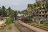 SLR Class M4 (MLW MX620) approaches Mount Lavinia with 8749 1430 Colombo Maradana - Panadura; with Colombo visible along the beach