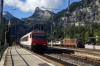 SBB 460049 runs through Kandersteg while BLS Re425 162 waits with a car train for Goppenstein