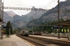 BLS Re465 465018 runs through Kandersteg with a freight while a BLS Re425 waits in the car transporter station with a Goppenstein bound car train