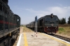 DK89 waits in the blistering sunshine at Sidi S'mail with 14 1150 Ghardimaou - Tunis, while DP152 approaches off the single line with 9 1015 Tunis - Ghardimaou