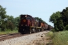 Southbound grain bound for Springdale passes by Exeter on the A&M Railroad headed by A&M Alco C420's 58/42 & BNSF GE ES44AC #6024
