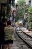 DSVN D19E-948 heads south from Hanoi, through "Railway Street" with SE35 1310 Hanoi - Vinh