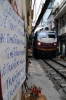 DSVN D19E-948 heads south from Hanoi, through "Railway Street" with SE35 1310 Hanoi - Vinh