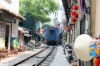 DSVN D19E-948 heads south from Hanoi, through "Railway Street" with SE35 1310 Hanoi - Vinh